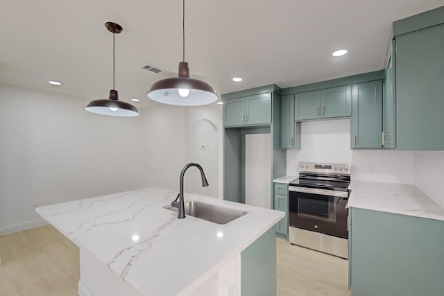 kitchen featuring stainless steel electric range oven, sink, hanging light fixtures, light stone counters, and a kitchen island with sink