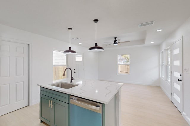 kitchen featuring pendant lighting, dishwasher, sink, ceiling fan, and light stone counters