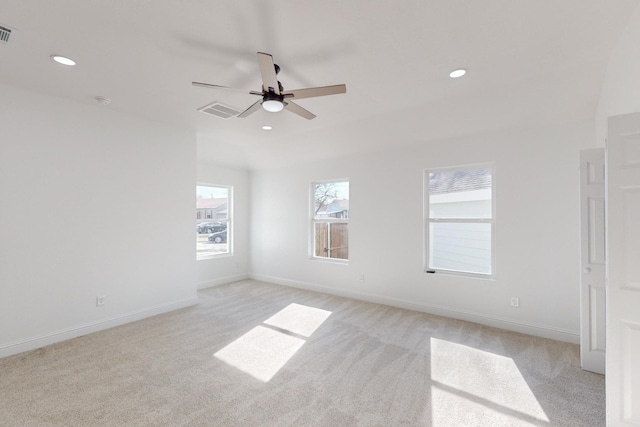 empty room with ceiling fan and light colored carpet