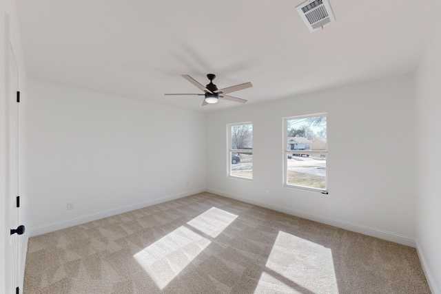 spare room featuring ceiling fan and light carpet