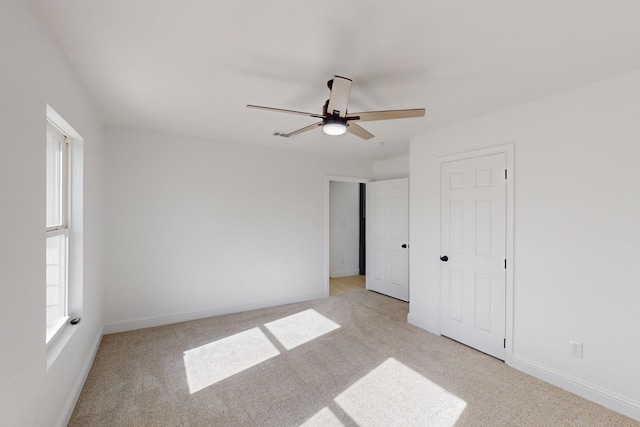 unfurnished bedroom with ceiling fan and light carpet