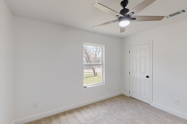 spare room featuring light carpet and ceiling fan