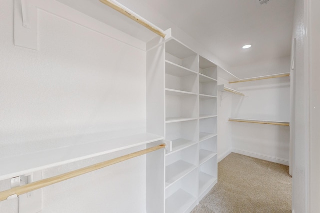 walk in closet with carpet