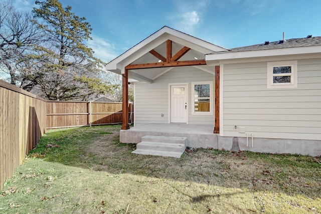 rear view of house featuring a yard