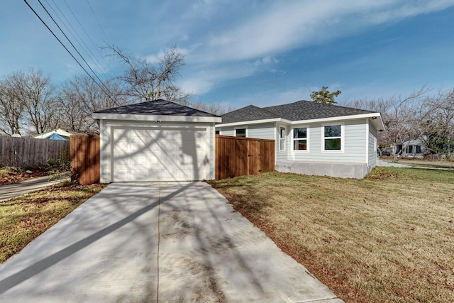 ranch-style house featuring a garage and a front lawn