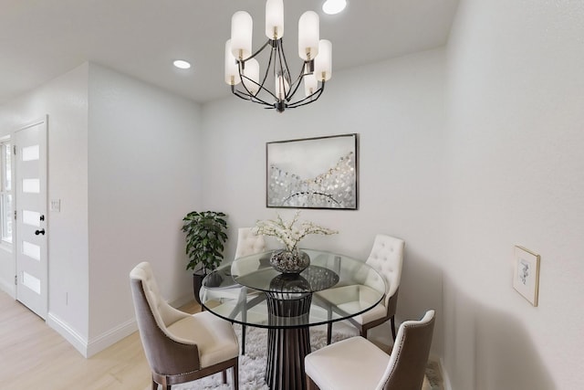 dining room featuring light hardwood / wood-style floors and a notable chandelier