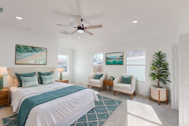 bedroom with ceiling fan and light carpet