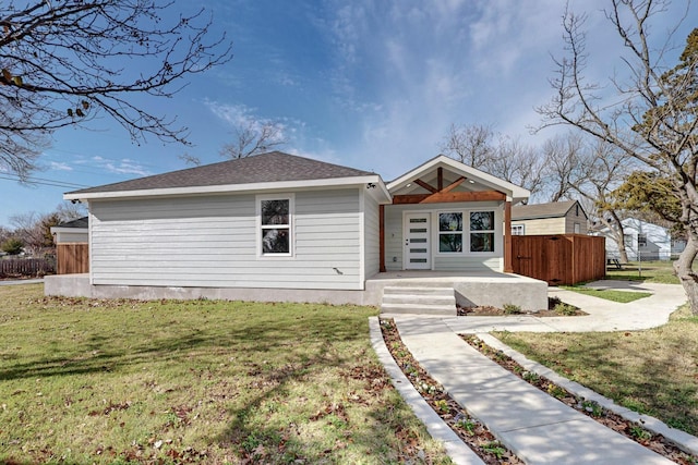 rear view of property featuring a yard