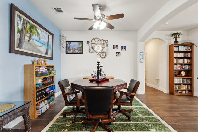 dining space featuring ceiling fan and dark hardwood / wood-style flooring