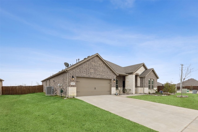 french country inspired facade featuring a front yard, a garage, and central AC unit