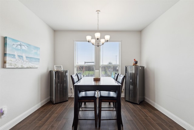 dining space with dark hardwood / wood-style floors and an inviting chandelier