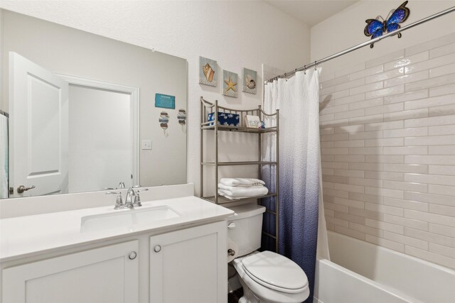 full bathroom featuring shower / bath combo, vanity, and toilet