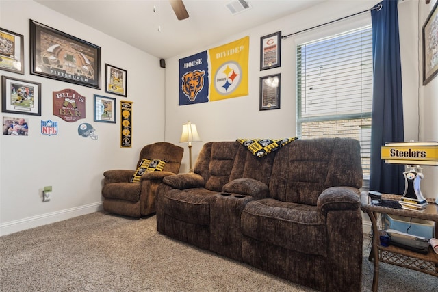 home theater room with ceiling fan and carpet