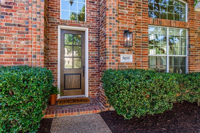 view of exterior entry with brick siding