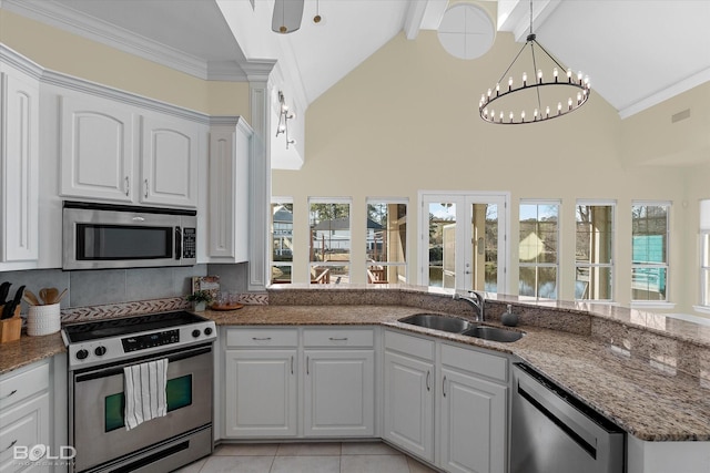 kitchen featuring white cabinets, appliances with stainless steel finishes, an inviting chandelier, sink, and beam ceiling