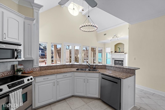 kitchen featuring kitchen peninsula, sink, light tile patterned flooring, white cabinetry, and appliances with stainless steel finishes