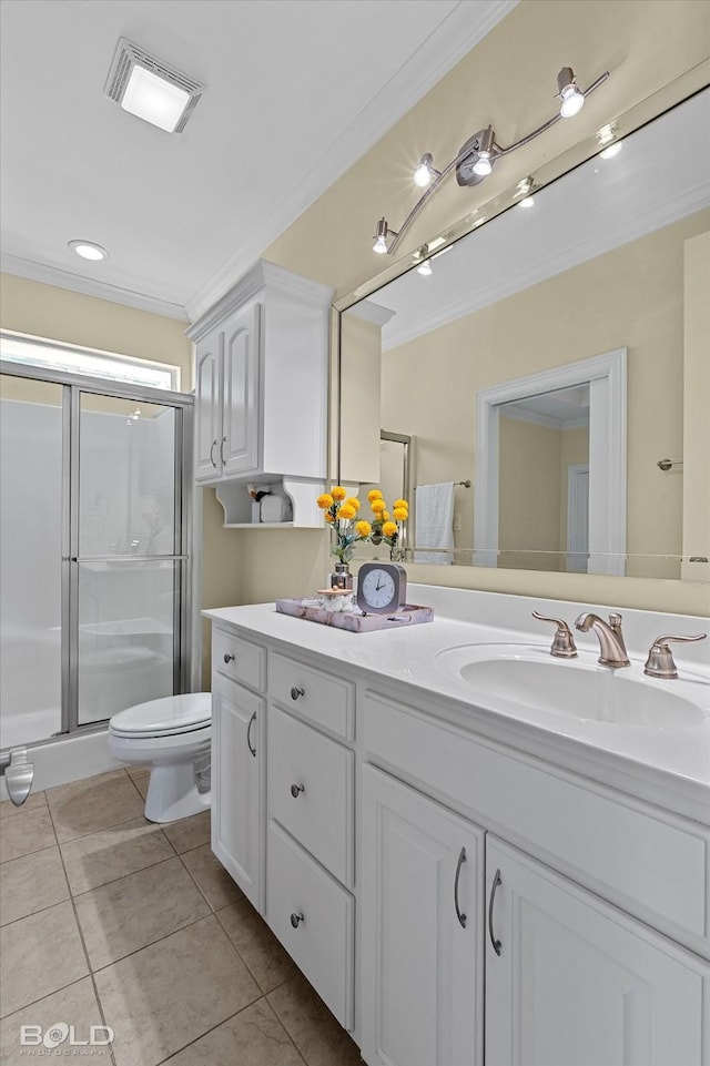 bathroom featuring tile patterned flooring, vanity, toilet, walk in shower, and crown molding