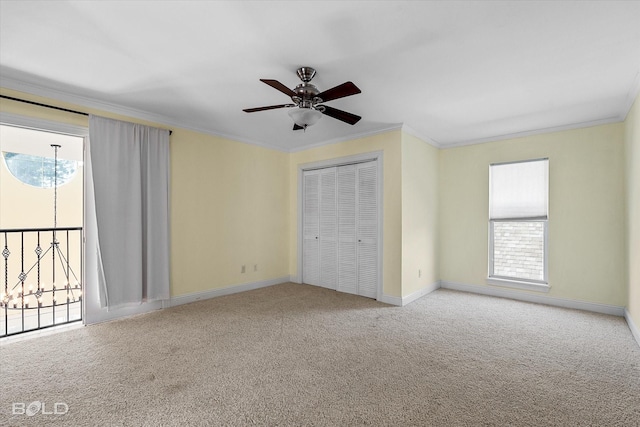 unfurnished bedroom with ceiling fan, light colored carpet, a closet, and crown molding