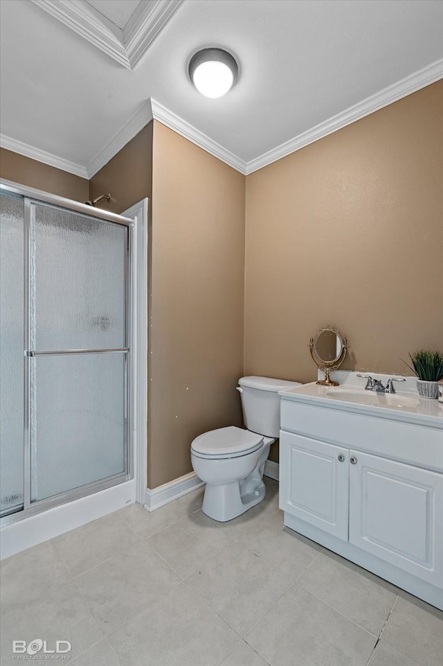 bathroom with vanity, toilet, ornamental molding, and a shower with door