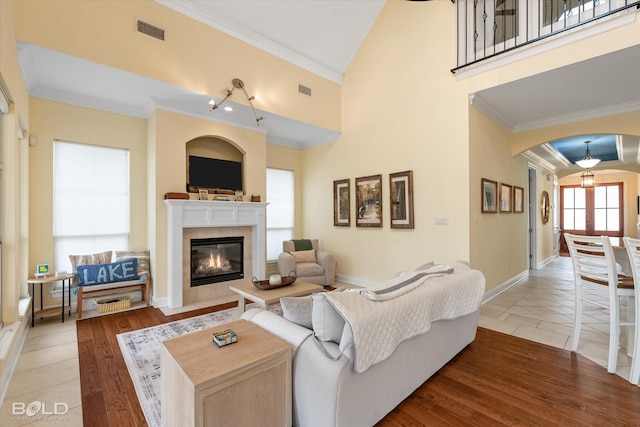 living room featuring ornamental molding and light hardwood / wood-style floors