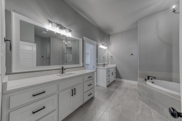 bathroom featuring plus walk in shower, vanity, and tile patterned floors