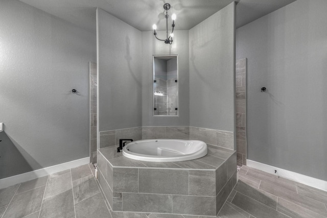 bathroom featuring tile patterned flooring, a notable chandelier, and plus walk in shower