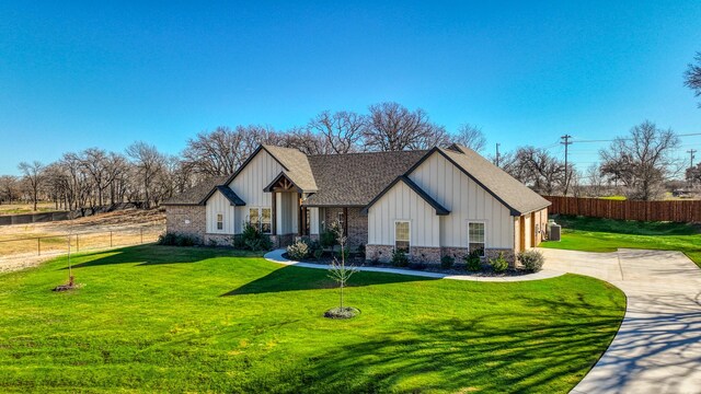 modern inspired farmhouse with roof with shingles, board and batten siding, and driveway