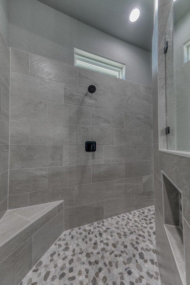 bathroom with tiled shower