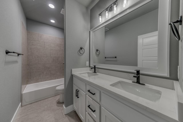 full bathroom featuring tile patterned flooring, vanity, toilet, and tiled shower / bath