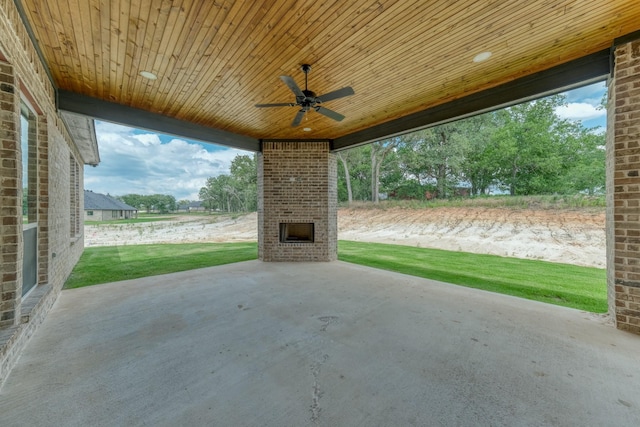 view of patio / terrace featuring ceiling fan and an outdoor brick fireplace