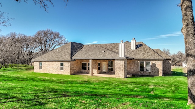 back of property featuring a patio area and a yard