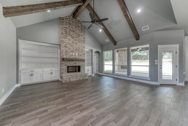 unfurnished living room with high vaulted ceiling, baseboards, arched walkways, a ceiling fan, and beamed ceiling