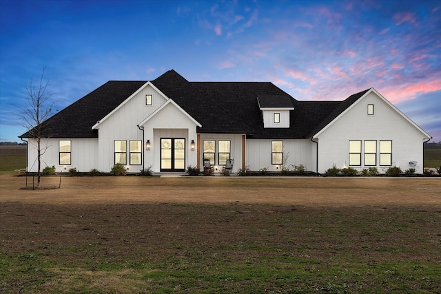 modern farmhouse featuring french doors and a yard