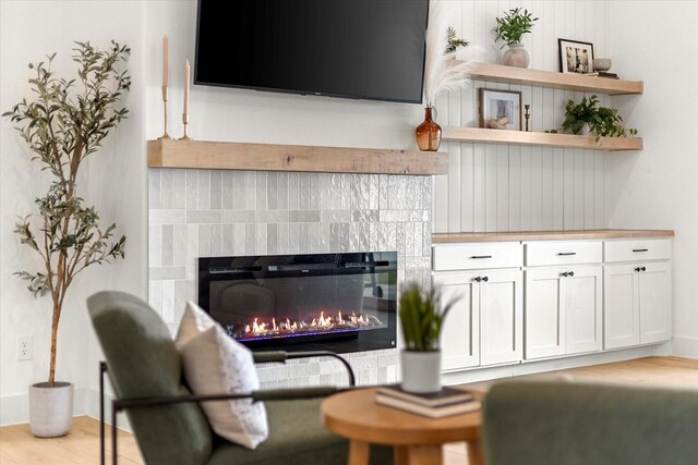 living room featuring a tiled fireplace