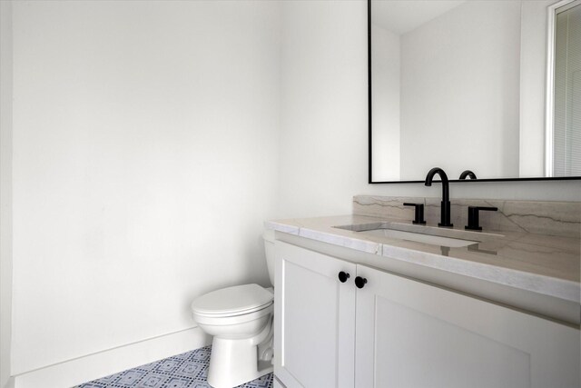 bathroom with vanity and toilet