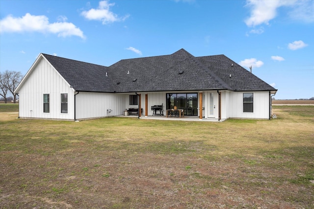 rear view of house with a lawn and a patio area