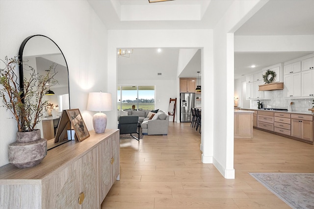 interior space featuring light wood-type flooring and an inviting chandelier