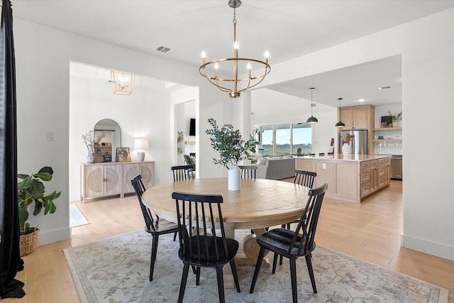 dining space featuring a chandelier and light hardwood / wood-style flooring