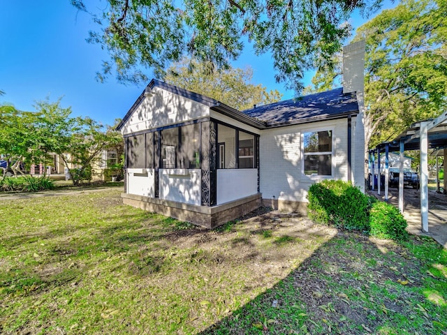 exterior space featuring a front yard and a sunroom