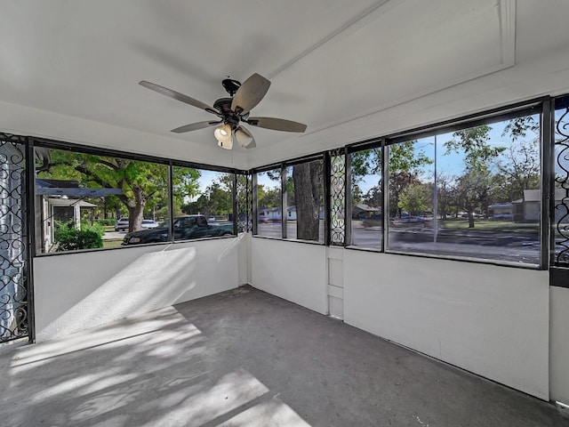 unfurnished sunroom with ceiling fan