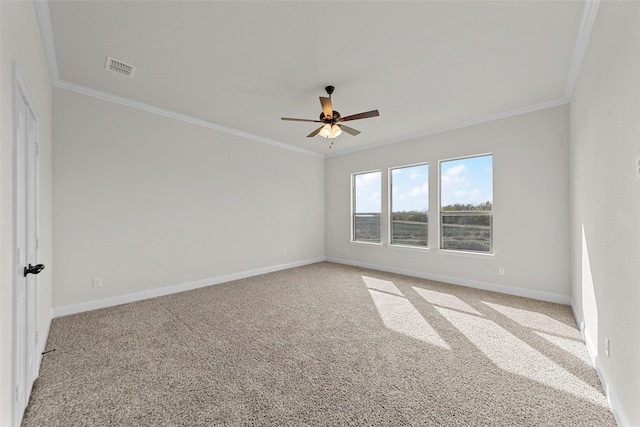 carpeted spare room featuring crown molding and ceiling fan