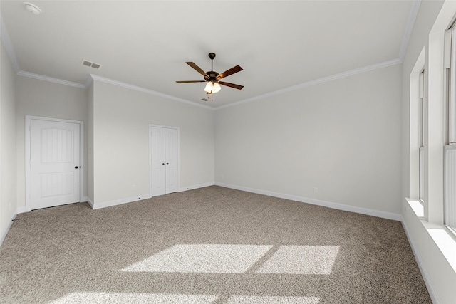 unfurnished room with ornamental molding, carpet flooring, and ceiling fan