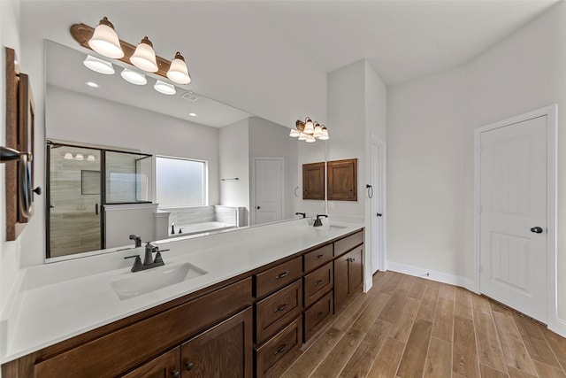 bathroom featuring wood-type flooring, vanity, and independent shower and bath