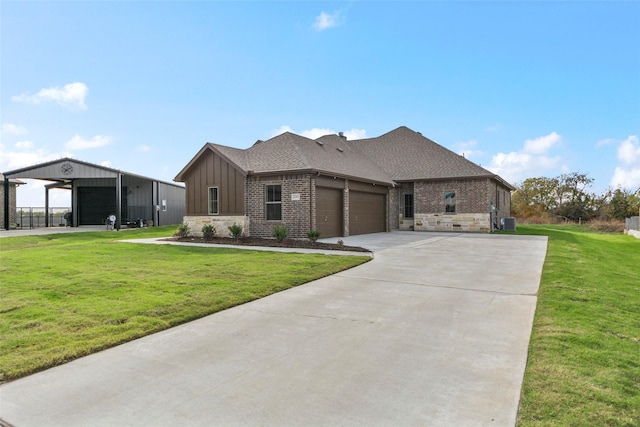 view of front of property with cooling unit, a front lawn, and a garage