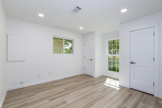 unfurnished room with light wood-type flooring