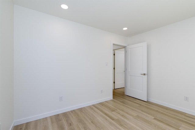 spare room with light hardwood / wood-style flooring