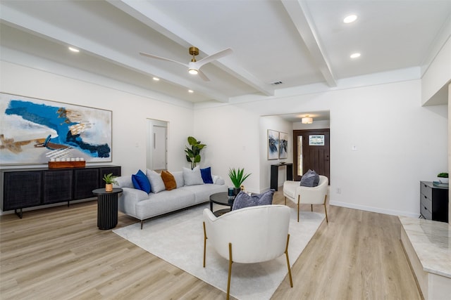 living room with beamed ceiling, light hardwood / wood-style floors, and ceiling fan