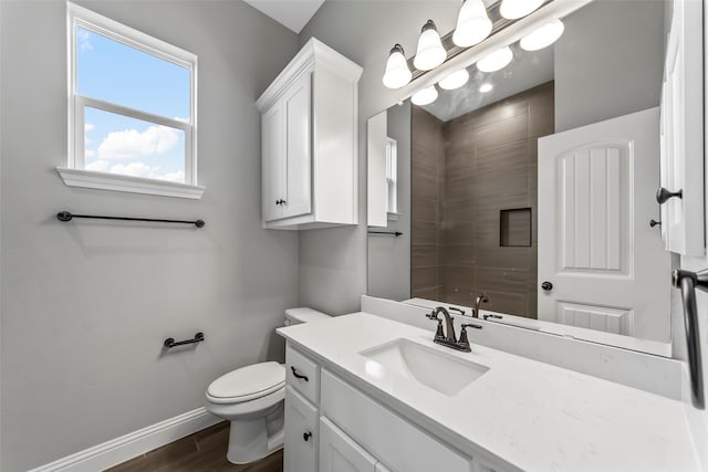 bathroom featuring vanity, hardwood / wood-style floors, and toilet