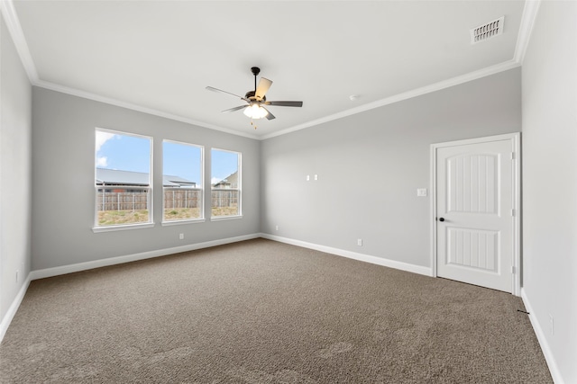 empty room with crown molding, ceiling fan, and carpet