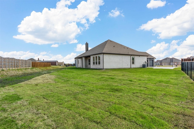 rear view of house with a yard